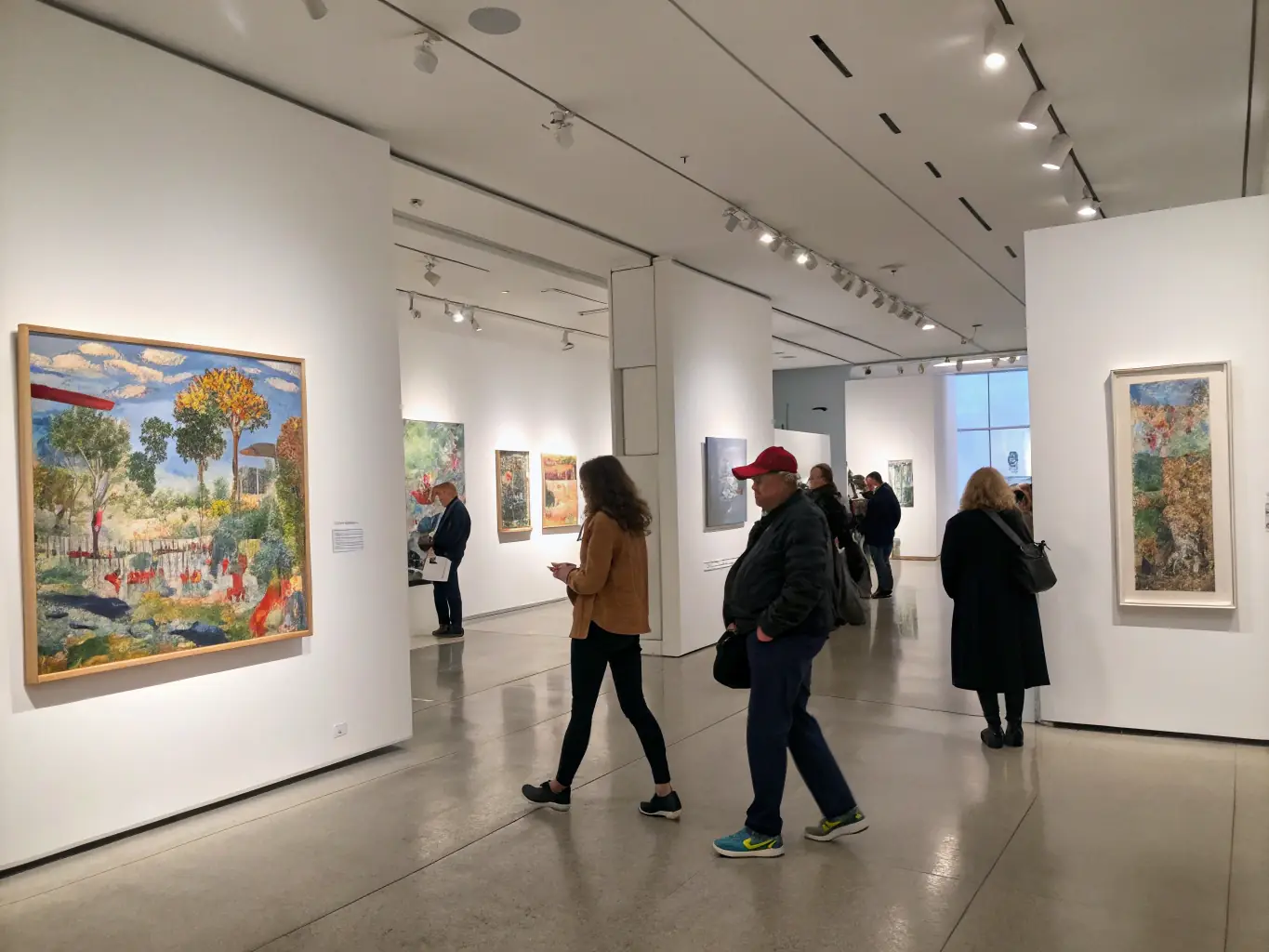 A photograph showcasing an exhibition featuring the artwork of emerging artists supported by EMERGENVOL, highlighting the promotional opportunities and public exposure provided through the organization.